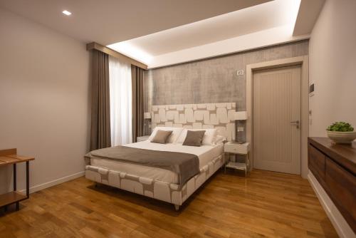 a bedroom with a large bed in a room at Noto Boutique Hotel in Noto