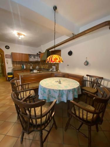 a dining room with a table and chairs at PM 25 Via Trepene in Castellonorato