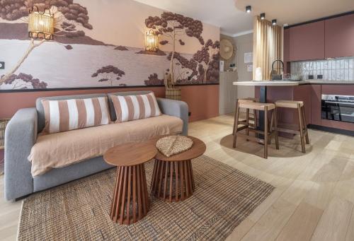 a living room with a couch and a table at Host Inn Sweet Croisette in Cannes