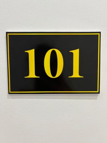 a sign with the number on a wall at Hotel Sisana in Vlorë