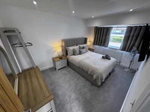 a bedroom with a bed and a window at Amora Stays in Buckinghamshire