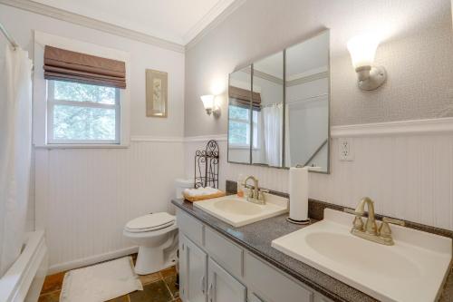 a white bathroom with two sinks and a toilet at Walk to Restaurants New Hope Home with Deck and Yard! in New Hope