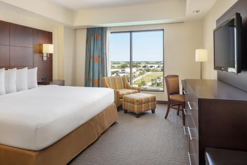a hotel room with a bed and a large window at Plaza Suites On International Drive Near Universal Epic in Orlando