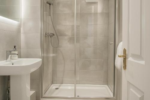 ein Badezimmer mit Dusche und Waschbecken in der Unterkunft St Andrews Apartments in Maidstone