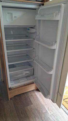 an empty refrigerator with its door open in a room at Blue Water Retreat Dawlish Warren Nr Beach in Dawlish Warren