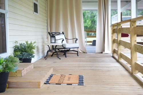 a porch with a bench and a table at Zephyrhills House for 4 people WiFi BBQ Mini Golf in Zephyrhills