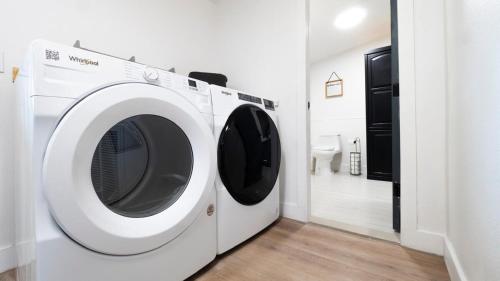 a white washing machine in a room with a bathroom at Zephyrhills House for 4 people WiFi BBQ Mini Golf in Zephyrhills