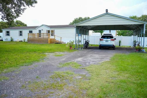 a garage with a car parked under it at Zephyrhills House for 4 people WiFi BBQ Mini Golf in Zephyrhills
