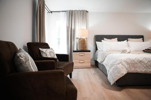 a bedroom with a bed and a couch and a chair at Zephyrhills House for 4 people WiFi BBQ Mini Golf in Zephyrhills