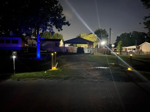 a driveway with lights in a yard at night at Zephyrhills House for 4 people WiFi BBQ Mini Golf in Zephyrhills
