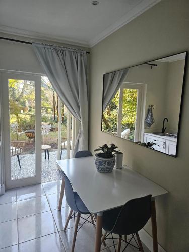 a dining room with a table and chairs and a mirror at The Rose Cottage in Hilton