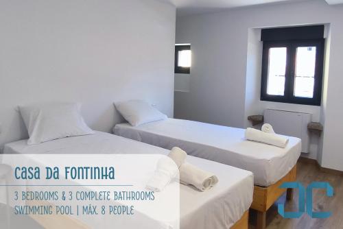 a room with two beds and a window at Casa da Fontinha - Swimming Pool & Free Parking 