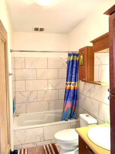 a bathroom with a tub and a toilet and a sink at 6 people, big, free parkings, near Old Quebec, near river in Quebec City