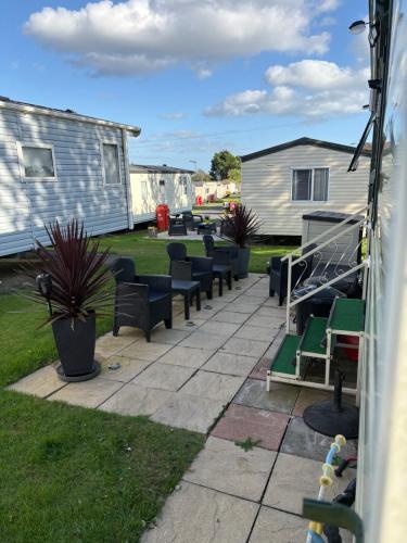a row of chairs sitting in a yard at Caravan AH26 in Laugharne