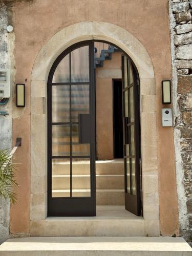 an entrance to a building with an open door at Santa Veneranda Suites "by Checkin" in Ayía Paraskeví