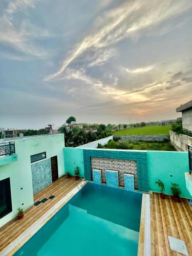 a roof top view of a house with a swimming pool at ZenRoofs - Pool Farm House in Jaipur