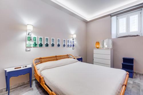 a bedroom with a bed and blue tables and a window at LuxurySistersHouse 2 min Colosseum in Rome