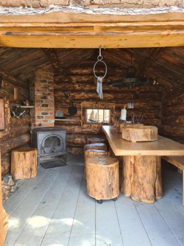 a wooden cabin with a table and a fireplace at Villa Västanro Skärgårdsstuga på egen ö med båtskjuts in Sund