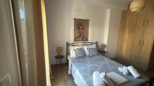 a bedroom with a bed and a painting on the wall at Kalisti Apartment in Lixouri