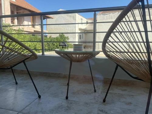 two chairs and a table on a balcony at Kalisti Apartment in Lixouri