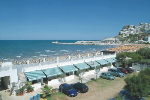 a parking lot next to a beach with cars parked at B&B Bellariva in Peschici