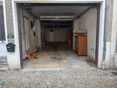 an empty hallway of a building with a garage at Repère des Templiers in Bouillon