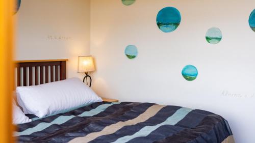 a bedroom with a bed and lights on the wall at Hotel Rangá in Hella