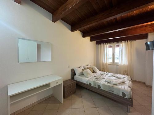 a bedroom with a bed and a table and a window at Le due torri in Lecce neʼ Marsi