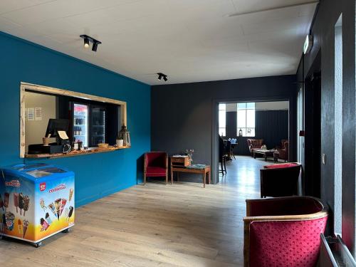 a living room with blue walls and a table and chairs at Hotel Studlagil in Skjöldólfsstaðir