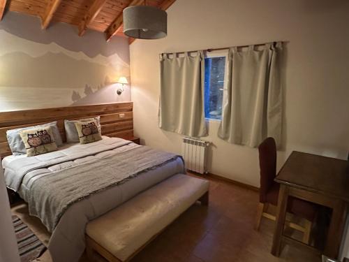a bedroom with a bed and a window at Casa Llao alojamiento de montaña in San Carlos de Bariloche