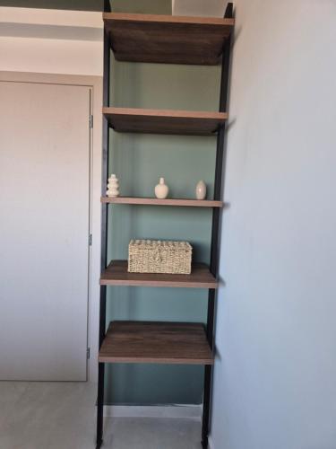 a book shelf with a basket on it at Allargo Project in Gerani
