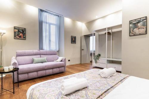 a living room with a purple couch and a bed at luxury house - como lake in Como