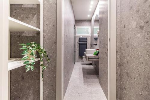a hallway with a bathroom with a plant in it at luxury house - como lake in Como