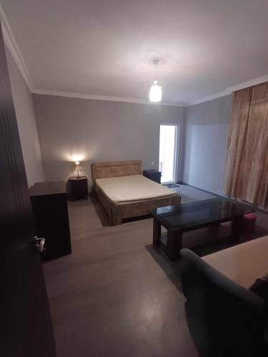 a room with a bed and a table in it at Шода in Gari