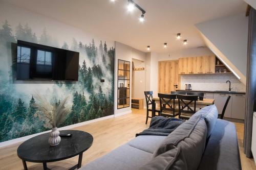 a living room with a couch and a table at Willa Jodełka in Zakopane