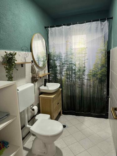 a bathroom with a toilet and a sink and a shower curtain at Cottage Arinda in Jajce