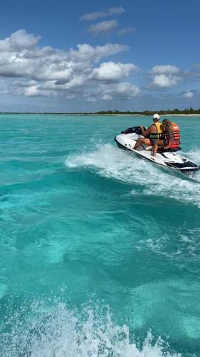 two people on a jet ski in the water at Portal Mar Pousada in Maragogi