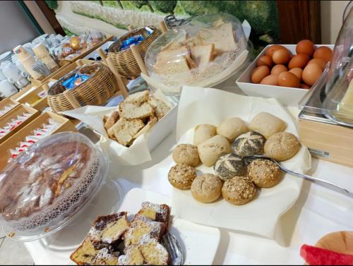 a table topped with different types of pastries and eggs at Hotel San Francesco in San Giovanni Rotondo