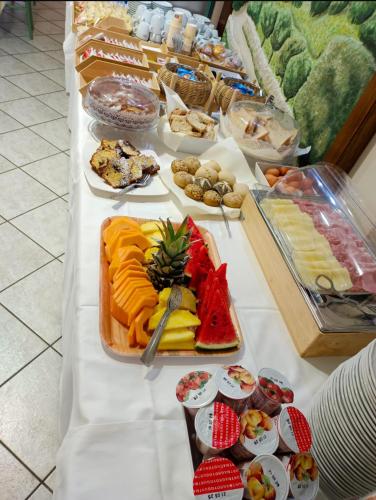 a buffet of food on a white table at Hotel San Francesco in San Giovanni Rotondo