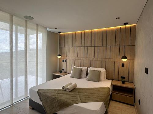 a bedroom with a large bed and a large window at Rancho De Nico in Estación El Salto