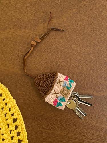 a pair of keys sitting on a table with a zipper at Vico Grazie in Campi Salentina