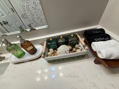 a bathroom counter with a tray of soap and towels at Savannah Lakefront Retreat near Tybee Beach with King Bed and Free Parking in Savannah
