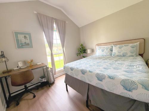a bedroom with a bed and a desk and a window at Savannah Lakefront Retreat near Tybee Beach with King Bed and Free Parking in Savannah