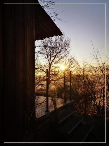 a view of the sunset from the porch of a house at La Pause En Soi in Ponlat-Taillebourg