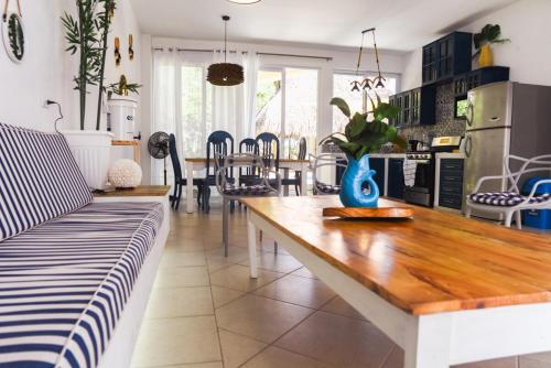 a kitchen and dining room with a wooden table at Villa Almendro - 4 habitaciones in Iztapa