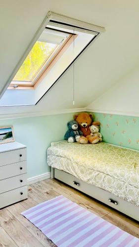 a bedroom with a bed with stuffed animals on it at Na Skraju Puszczy in Cieciory