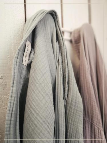 a bunch of clothes are hanging on a wall at La Pause En Soi in Ponlat-Taillebourg