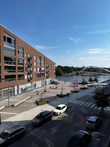 a parking lot with cars parked in front of a building at Great two bedrooms apartment with a sea view from the balcony close Helsinki center in Helsinki