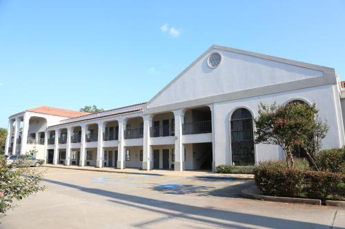 a large white building with a lot of windows at Americas Best Value Inn Monroe in Monroe