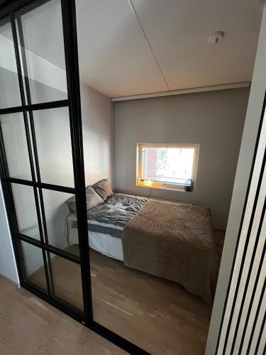 a bedroom with a bed and a window at Great two bedrooms apartment with a sea view from the balcony close Helsinki center in Helsinki